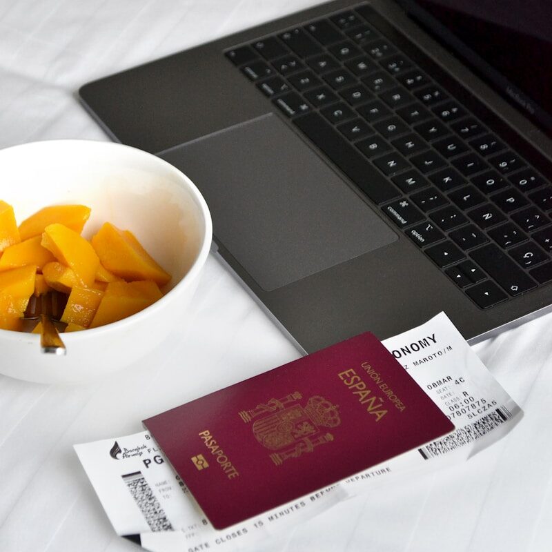 Travel essentials, passport, laptop and breakfast.